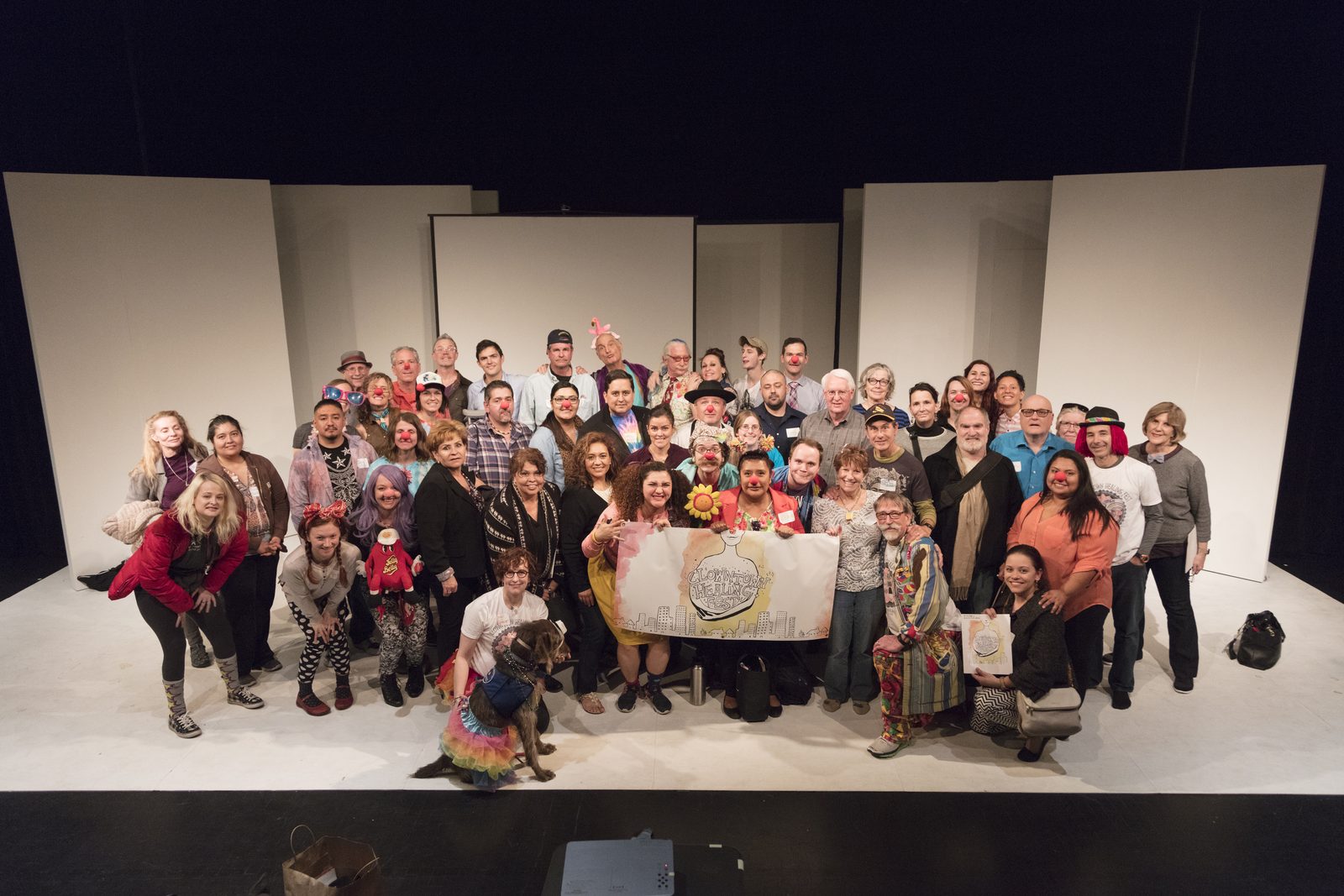 A wide outdoor photograph of a public gathering at the Clown Town Healing Fest in Phoenix.